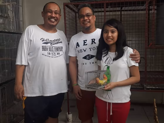 A happy family with the parrot they took home from Mysher Aviary