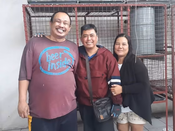 A happy family with the parrot they took home from Mysher Aviary